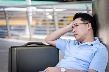 Depresyonda olan siyah çantalı bir iş adamı..