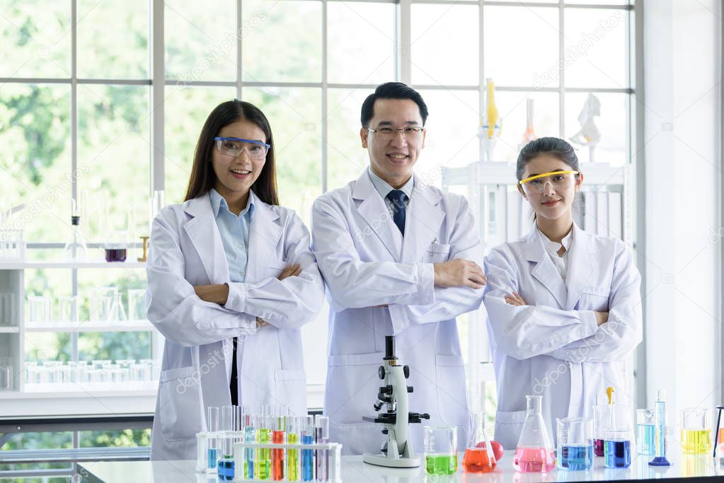 Asian senior scientist have teaching young student scientist in a laboratory.
