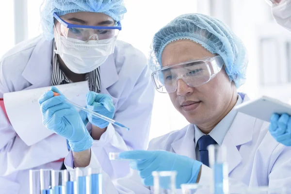 Asian scientist team has researching in laboratory. Stock Picture