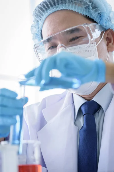 Asian man scientist researching  and learning in a laboratory. Stock Picture