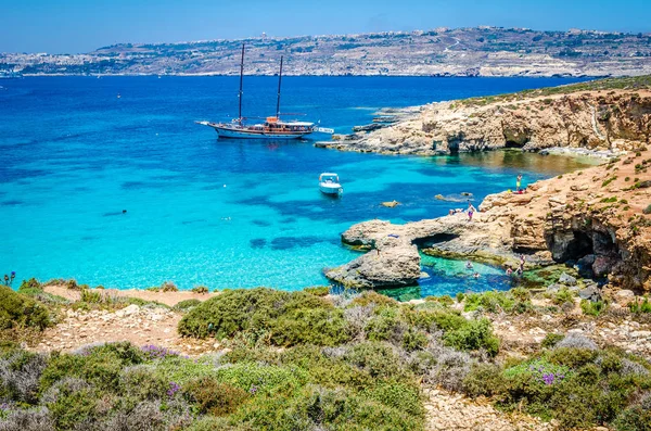 Blue Lagoon, Malta - the caves of the Blue Lagoon on the island of Comino on a bright sunny summer day with blue sky