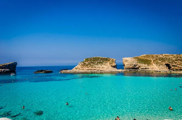 Blue Lagoon, Malta - the caves of the Blue Lagoon on the island of Comino on a bright sunny summer day with blue sky