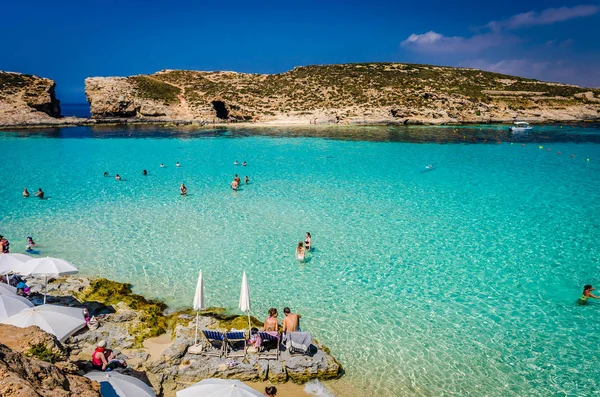 Blue Lagoon, Malta - the caves of the Blue Lagoon on the island of Comino on a bright sunny summer day with blue sky