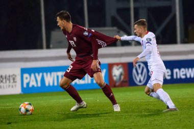 Riga, Letonya. 10 Ekim 2019. Vitalijs Jagodinskis (L) ve Sebastian Szymanski (R), Uefa Euro 2020 ön eleme maçında Letonya milli takımı ile Polonya milli takımı arasında oynandı.. 