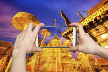 Wat Phra Bu DOI Suthep, Chiang Mai, Tayland popüler tarihi tapınakta gece görünümünü gösteren mobil akıllı telefon üzerinde fotoğraf çekimi kadın.