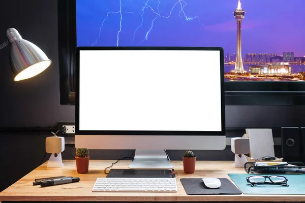 Graphic designer's workspace with a pen tablet, a computer and white backgroud for text with beautiful view of Cityscape in Macau from Window