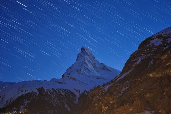 Beautiful star trails over the famous mountain Matterhorn at night in winter, Zermatt, Switzerland.