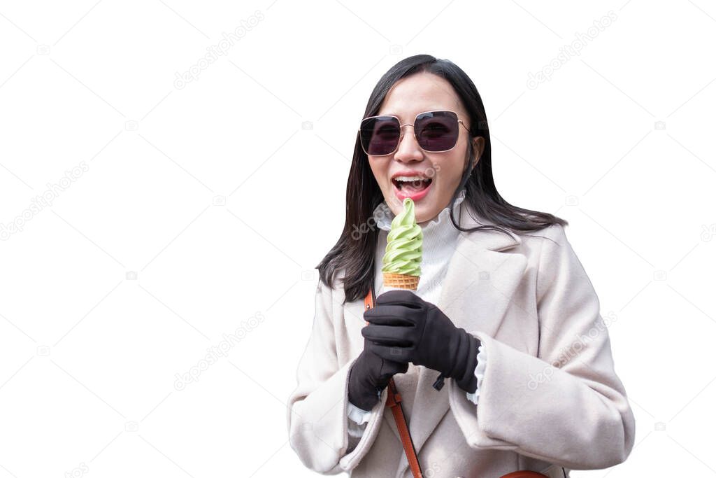 Young woman eating ice cream cone on white background