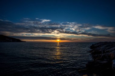 Gargano yarımadasında Peschici kasabası yakınlarında Adriyatik denizi üzerinde gün batımında bulutlar ile güzel gökyüzü, İtalya