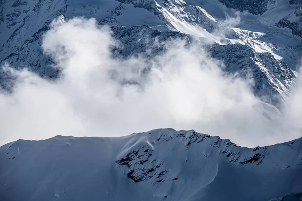 Wolken tussen de rotsen van de bergen — Stockfoto