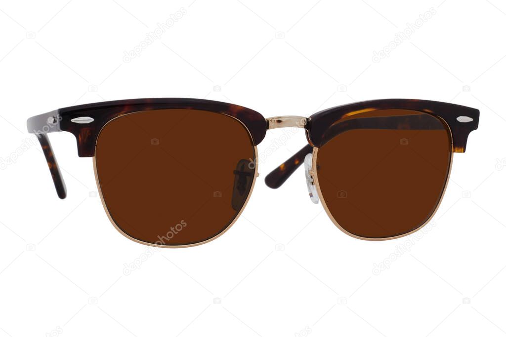 Sunglasses with a gold frame and brown lenses isolated on white background.
