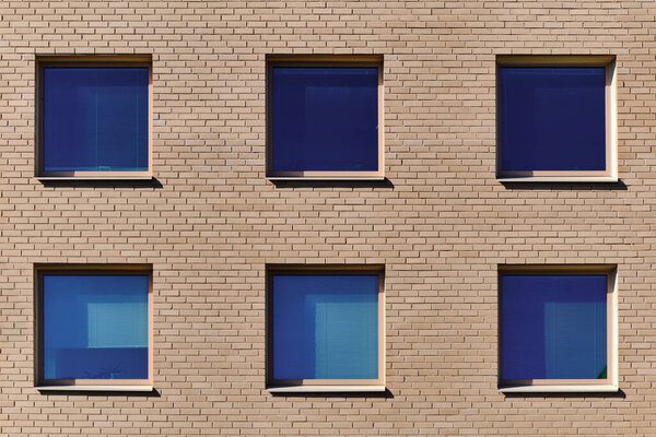The blue windows in the brick wall. Modern Nordic architecture in Finland.