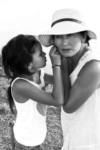 Grandmother and granddaughter spend the weekend in the park  in the sunny day.