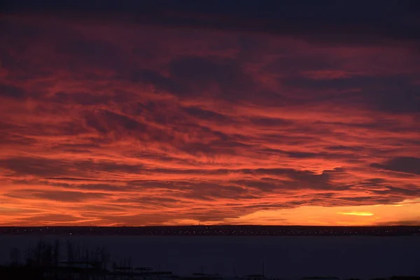 sunset over the lake, red clouds. winter landscape