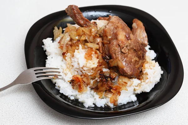 rice with meat and sauce on a plate