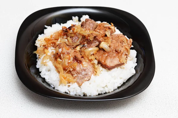 rice with meat and sauce on a plate