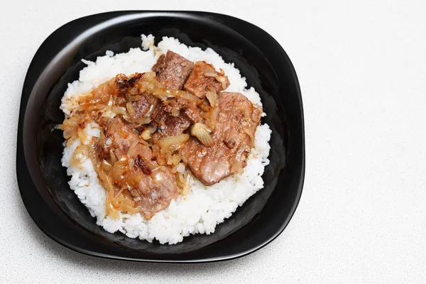 rice with meat and sauce on a plate