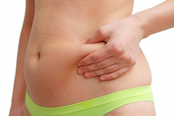 Woman Hand Holds Fold Excess Fat Her Stomach White Background — Stock Photo, Image