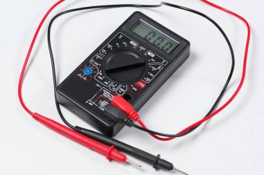 Elektrik donatımı ve elektrik devreleri kontrol etmek için bir araç. Beyaz arka plan üzerinde dijital multimetre.