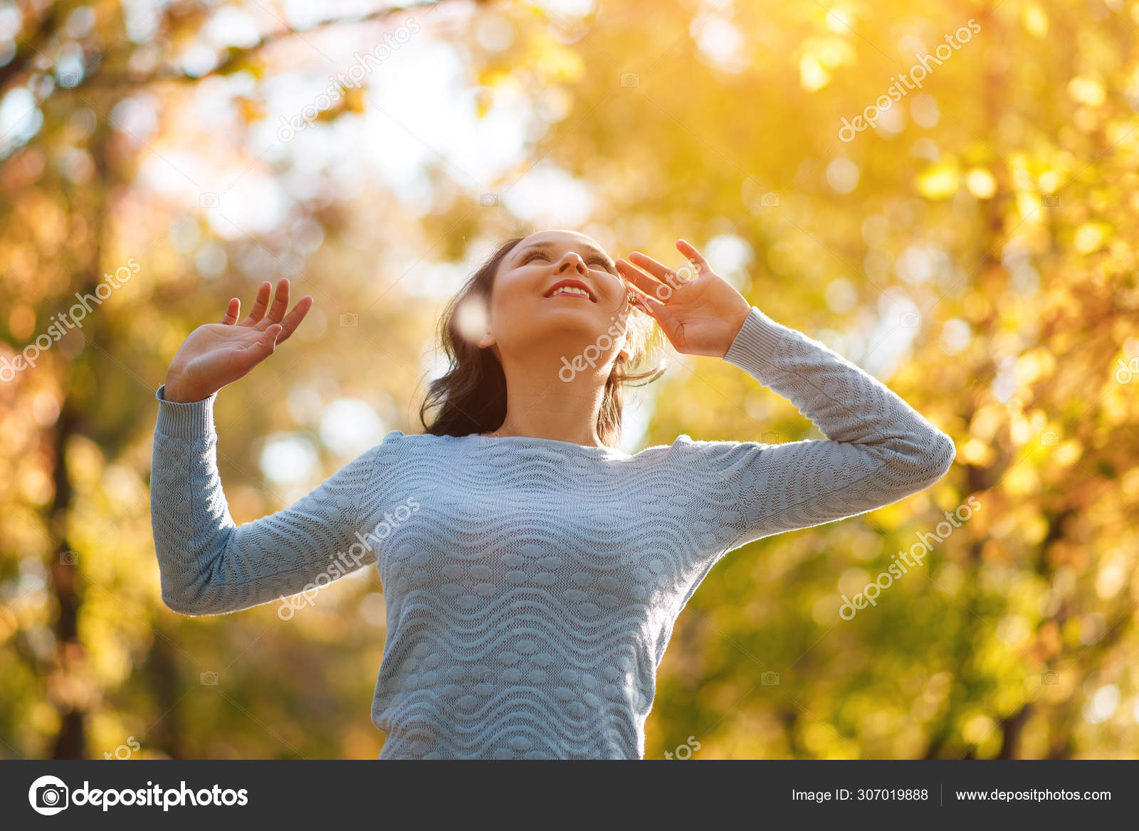 Happy Woman Enjoying Life in the Autumn on the Nature Stock Photo