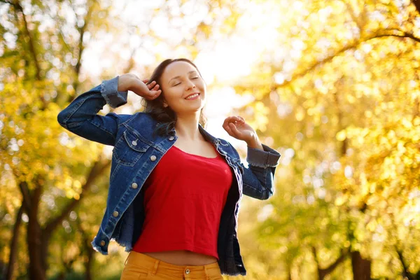 Happy Woman Enjoying Life in the Autumn on the Nature Stock Photo