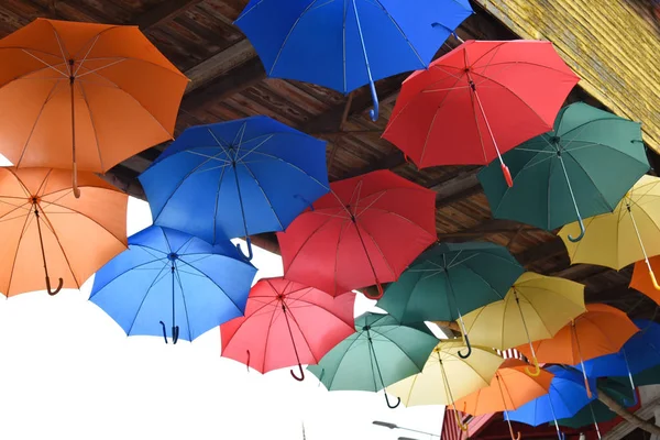 Many bright multicolored umbrellas under ceiling. fun, revelry. — Stock Image Many bright multicolored umbrellas under ceiling. fun, revelry. Stock Photo