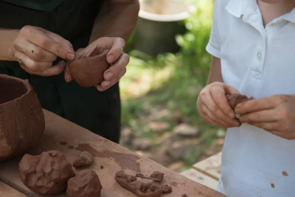 Close-up of childrens hands working with clay. The child makes dishes and other crafts. Pottery. Concept of Hobbies and Hobbies, comprehensive development of the child. — Stock Photo, Image