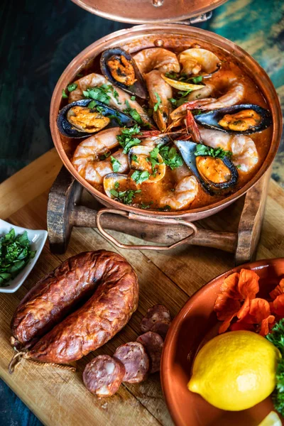 Traditional Portuguese ameijoas with clams served in a cataplana pot on the table