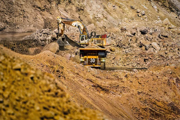 An open pit diamond mine in Botswana with heavy machinery on site.