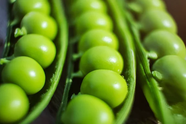 Peas in a pod close-up. Fresh pea harvest, macro photo. Concept of organic healthy wholesome vitamin food.