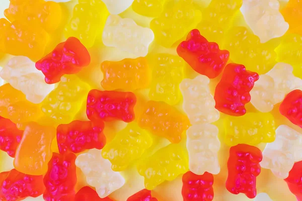 Jelly bears of different colors. The concept of junk sweets, candies. Minimalism, top view, flat lay, place for text.