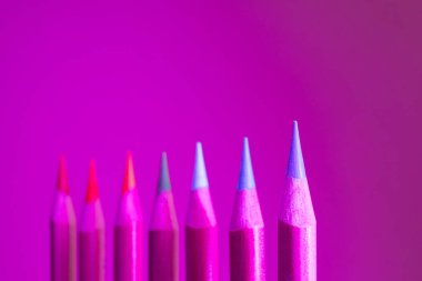 Renkli kalemler moda neon ışıklarda yakın plan çekiliyor. Sanatsal aksesuarlar, yaratıcılık kavramı. Metin ve minimalizm için yer.