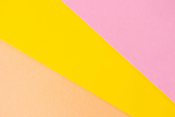 Colored paper, pastel, yellow, pink colors. Background image.