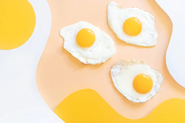 Telur Goreng Dengan Latar Belakang Gelombang Putih Dan Kuning Kertas — Stok Foto