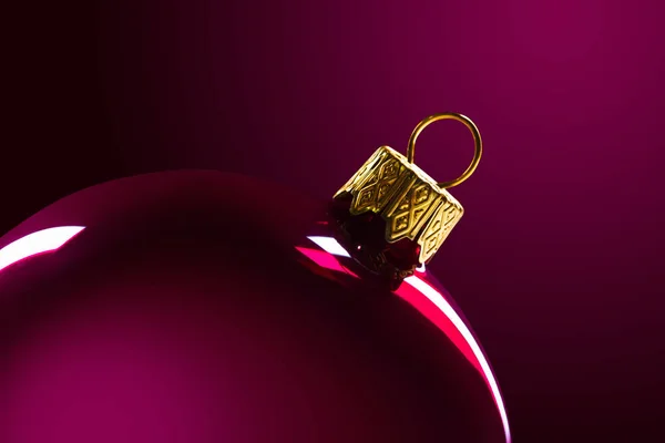 Red Christmas ball in backlight on a red background. Macro. Minimalism — Stock Photo, Image