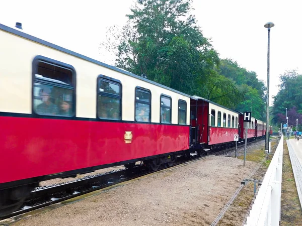 An arriving train in the station in the pouring rain