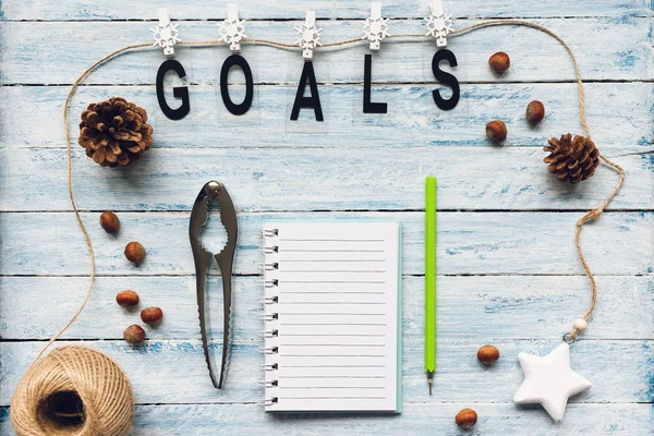 GOALS word and to do list on a blue and white wooden background. Top view, flat lay, mockup. Winter, Christmas and New Year celebration to do list concept.