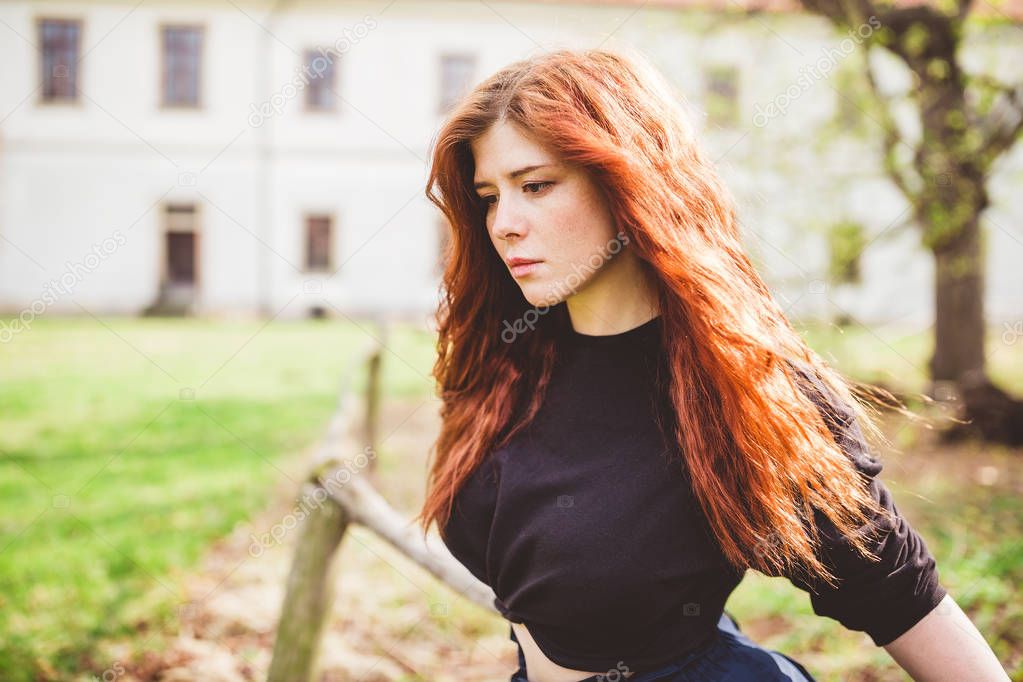 Beautiful redhead young woman outdoor portrait