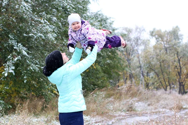 Mom and daughter and the first snow