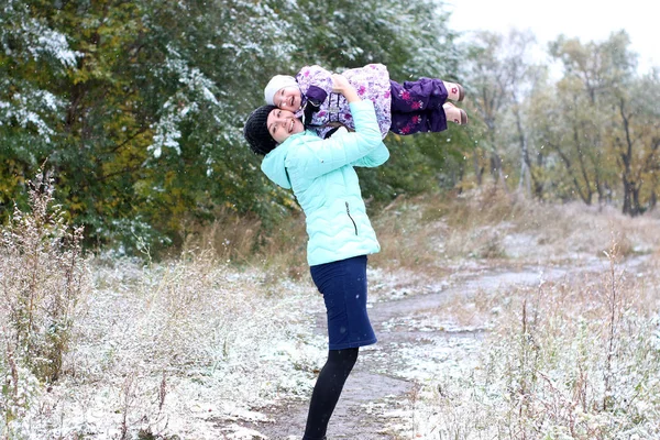 Mom and daughter and the first snow