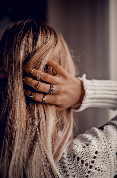 Hands with rings on hair