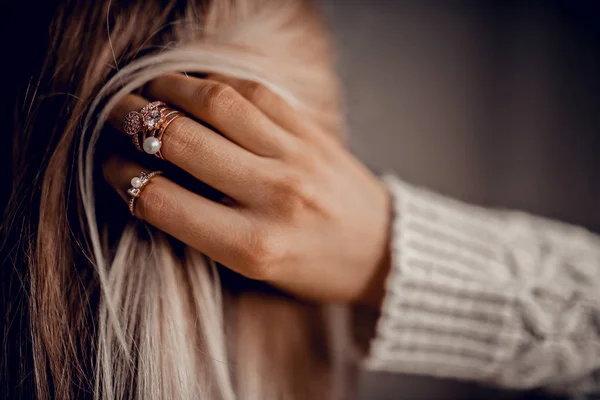 Hands with rings on hair