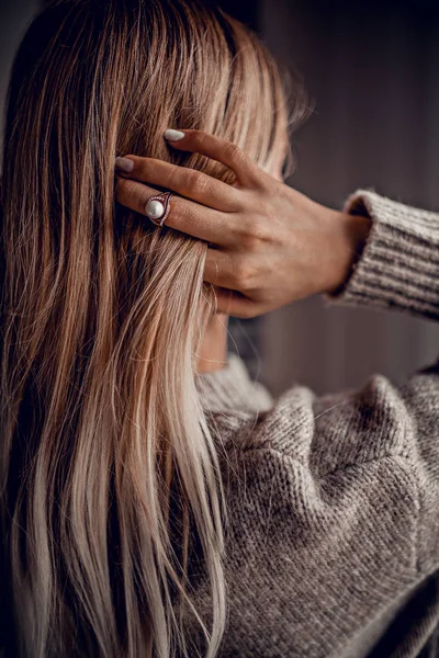 Hand with ring on hair