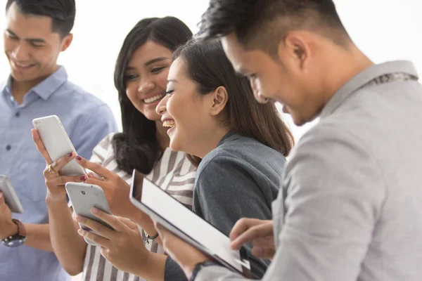 Group of young business people with their own gadget — Stock Photo, Image