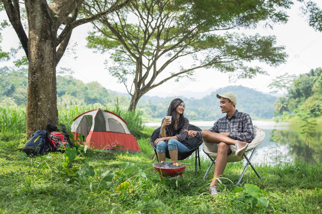 two asian couple in nature camping