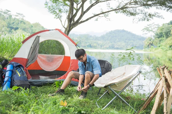 man camping by the lake