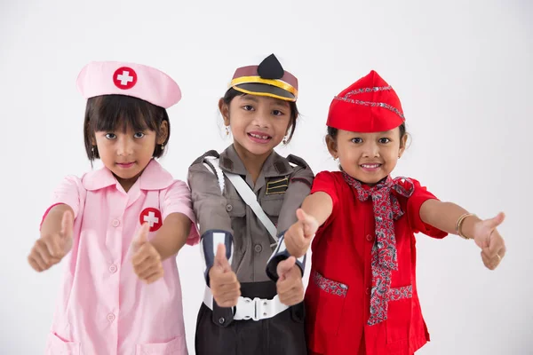 Trois petite fille en uniforme de profession différente — Photo
