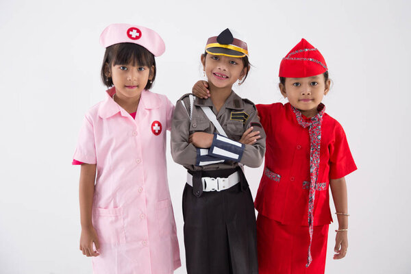 Three little girl in different profession uniform — Stock Photo, Image