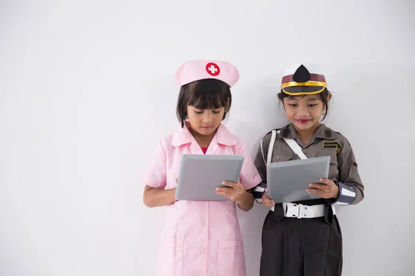 Little kids profession to be police and nurse — Stock Photo, Image