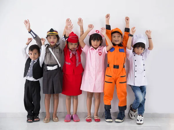 Niños vestidos con trajes de diferentes profesiones —  Fotos de Stock